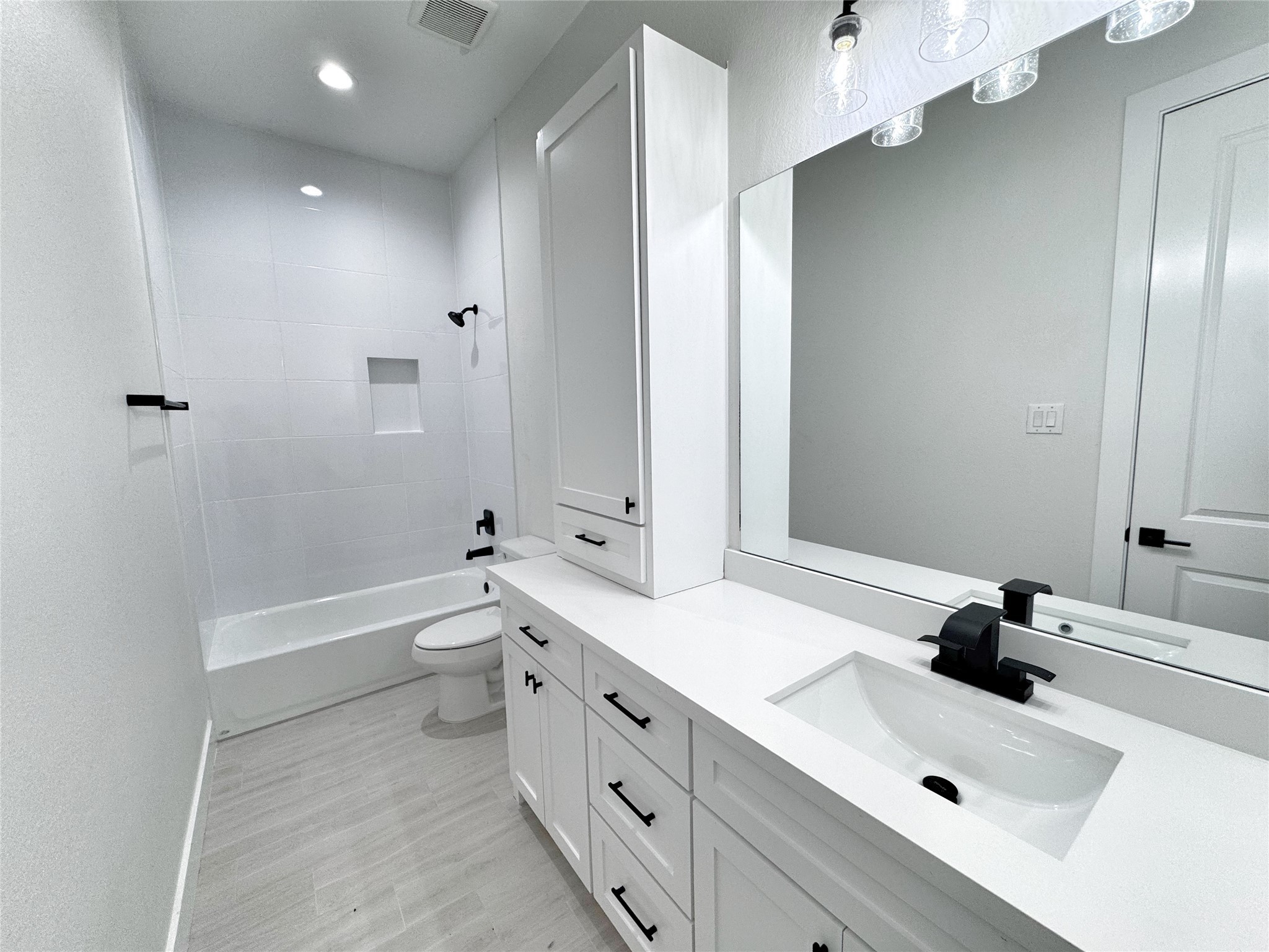 27710 Colapis Drive Splendora, TX 77372 - Photo 44 of 49 a bathroom with a tub sink toilet and mirror