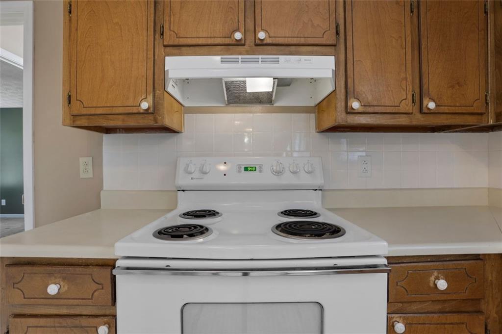 4378 Ridge Court Loganville, GA 30052 - Photo 12 of 47 a kitchen with a stove and cabinets