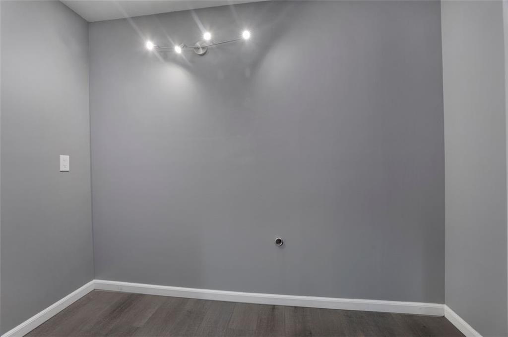 4378 Ridge Court Loganville, GA 30052 - Photo 14 of 47 a view of an empty room with wooden floor and a window