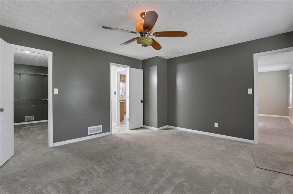 4378 Ridge Court Loganville, GA 30052 - Photo 16 of 47 a view of an empty room with a ceiling fan