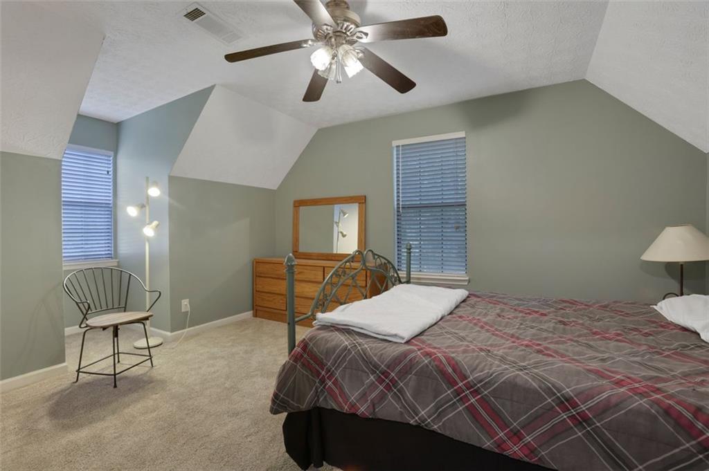 4378 Ridge Court Loganville, GA 30052 - Photo 23 of 47 a bedroom with a bed and chair