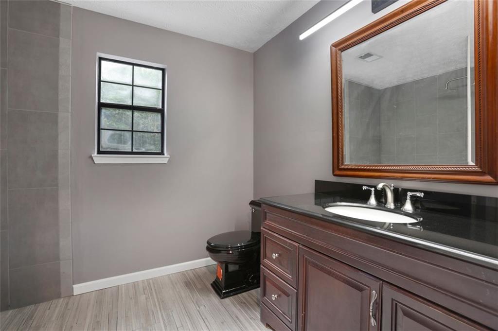 4378 Ridge Court Loganville, GA 30052 - Photo 25 of 47 a bathroom with a sink and a mirror