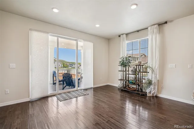 an empty room with wooden floor and a window
