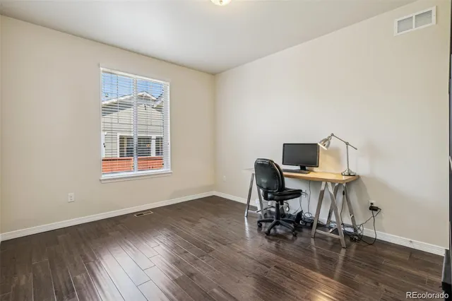 a workspace with furniture and wooden floor