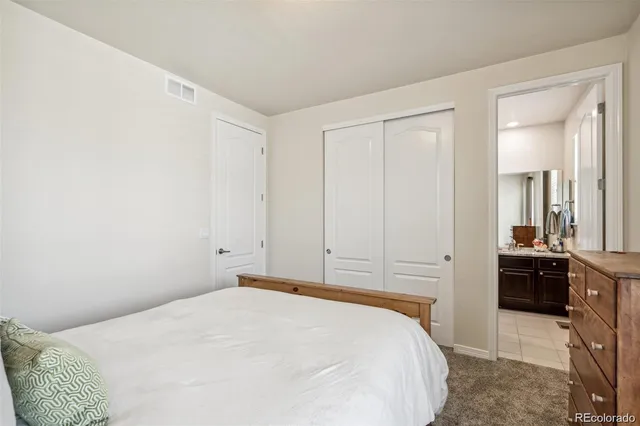 a bedroom with a bed and a view of bathroom