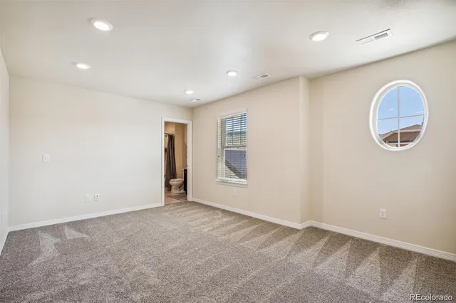 an empty room with a cabinet and a window