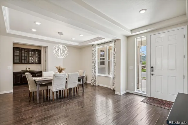 a view of a dining room with furniture and wooden floor