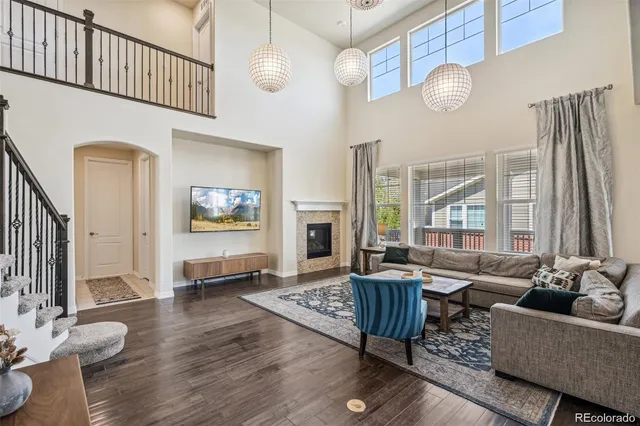 a living room with furniture fireplace and a large window