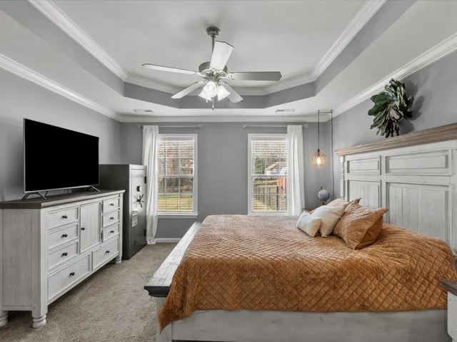 a bedroom with a large bed and flat tv