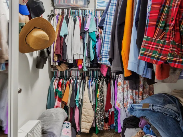 a view of walk in closet with clothes and shoes