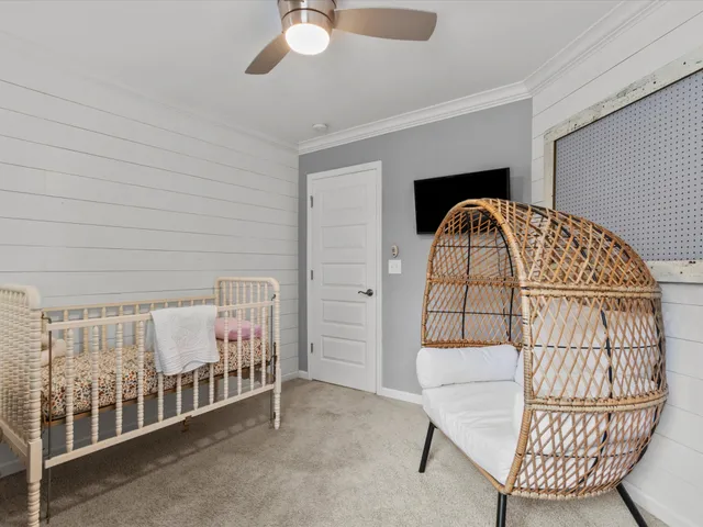 a bedroom with furniture and baby crib