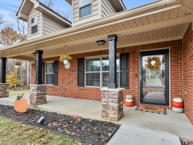 a view of a house with swimming pool and porch