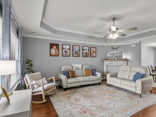 a living room with furniture and a chandelier