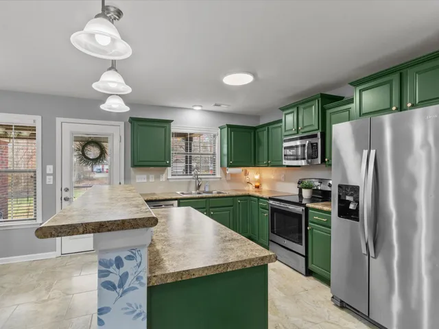 a kitchen with sink cabinets and refrigerator