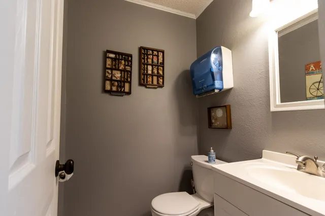 a bathroom with a toilet sink and mirror