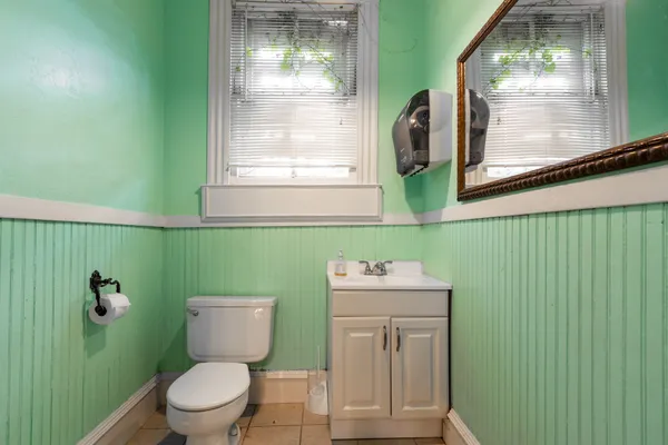 a view of a hallway with furniture and a chandelier