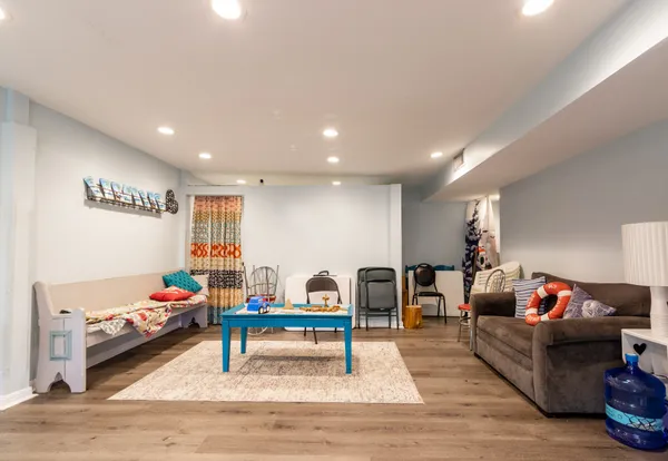 a playing room with furniture and a wooden floor