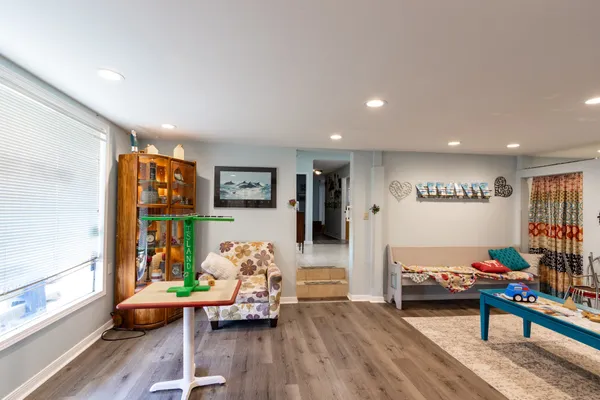 a living room with furniture and painting on the wall