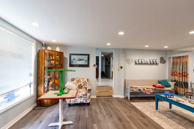 a living room with furniture and painting on the wall