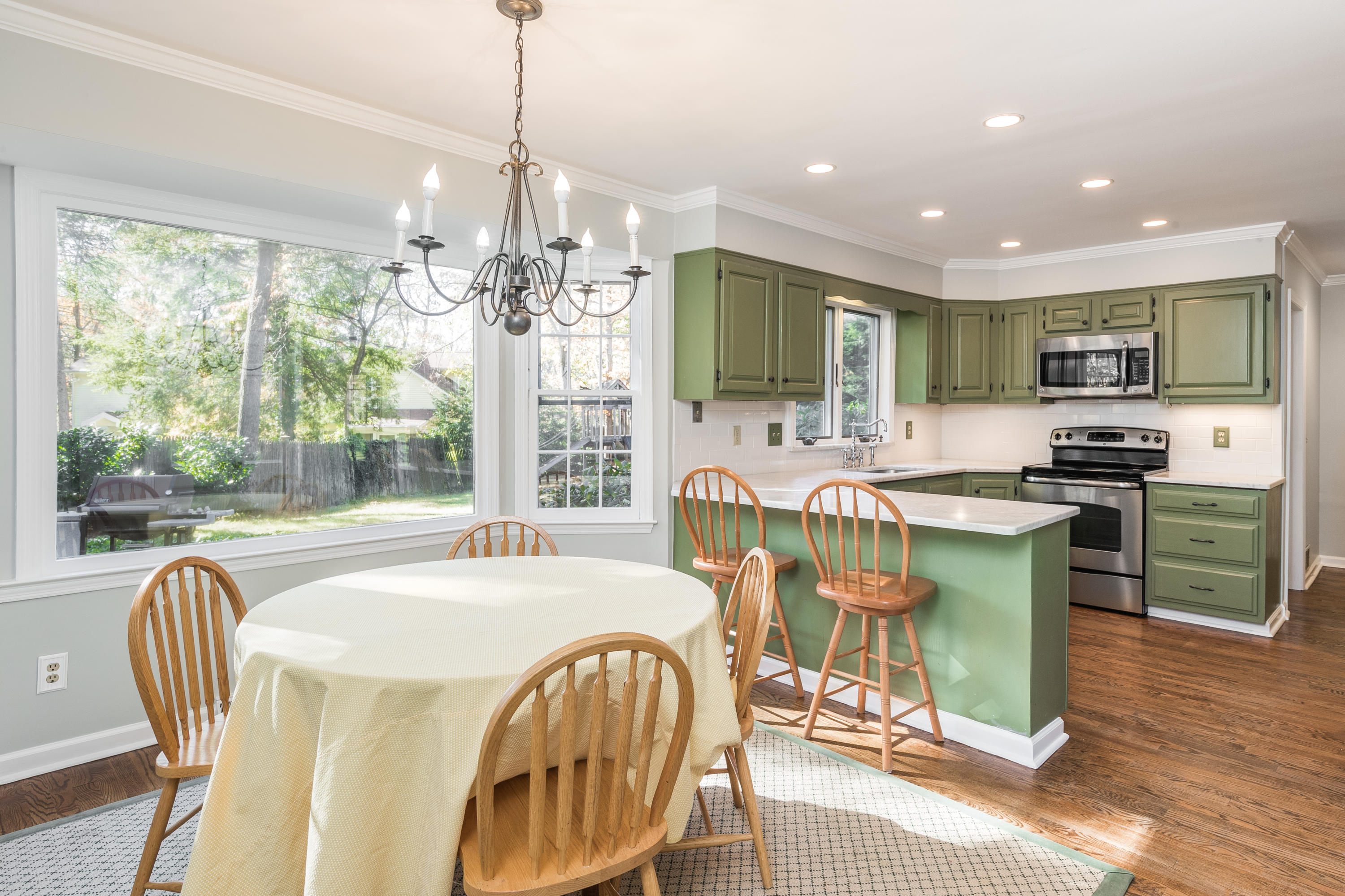 21 Barringer Road Darien, CT 06820 - Photo 16 of 34 a dining room with furniture a chandelier and wooden floor