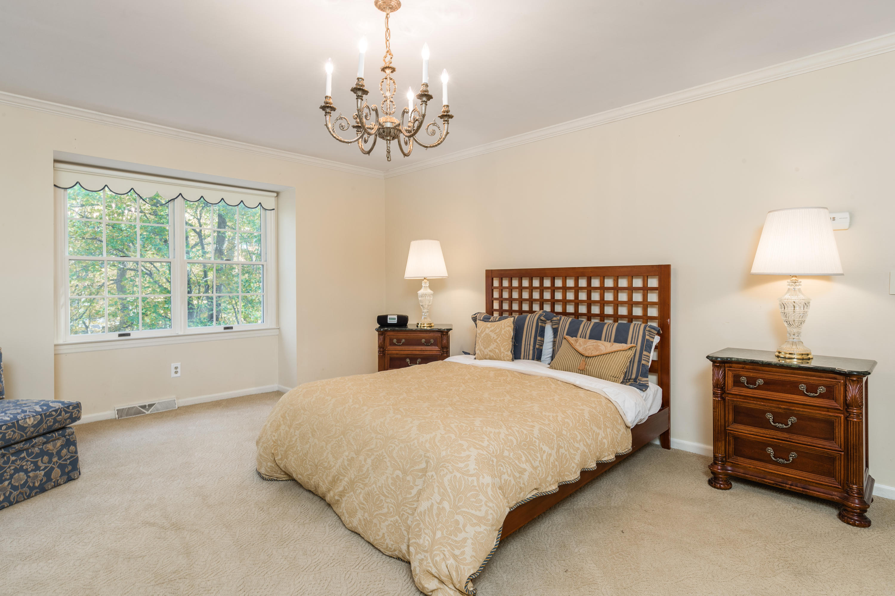 21 Barringer Road Darien, CT 06820 - Photo 18 of 34 a bedroom with a bed and a chandelier