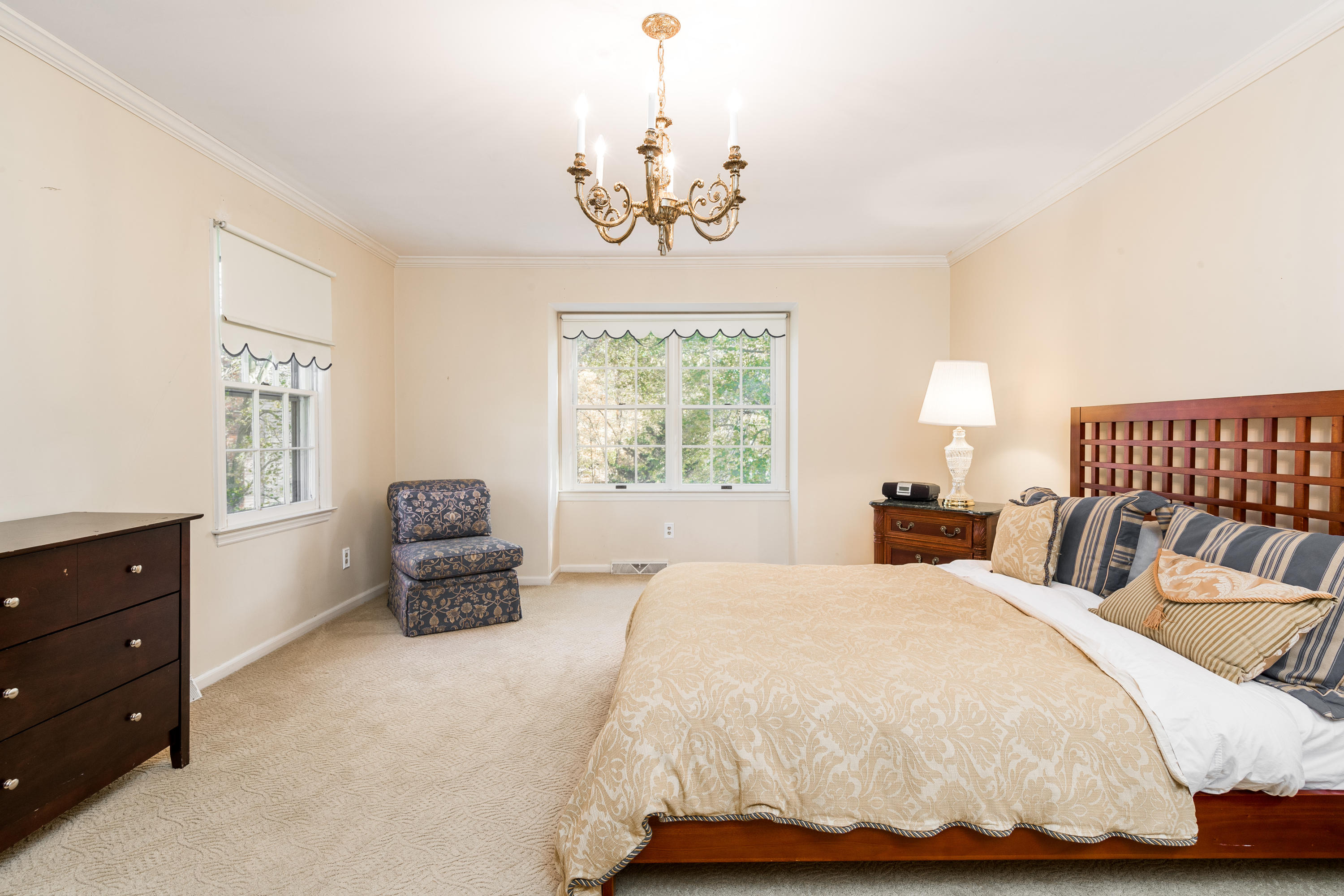 21 Barringer Road Darien, CT 06820 - Photo 19 of 34 a bedroom with a bed and a chandelier