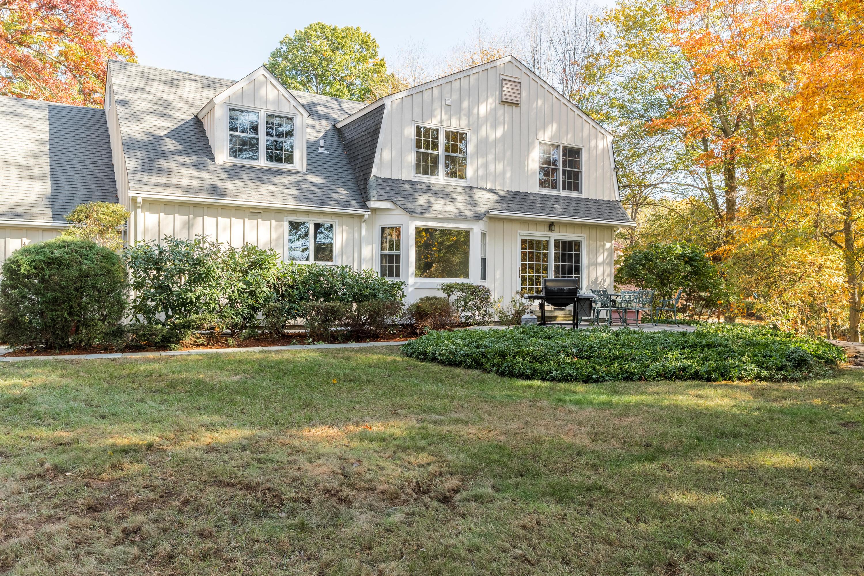 21 Barringer Road Darien, CT 06820 - Photo 29 of 34 a front view of a house with a yard and potted plants