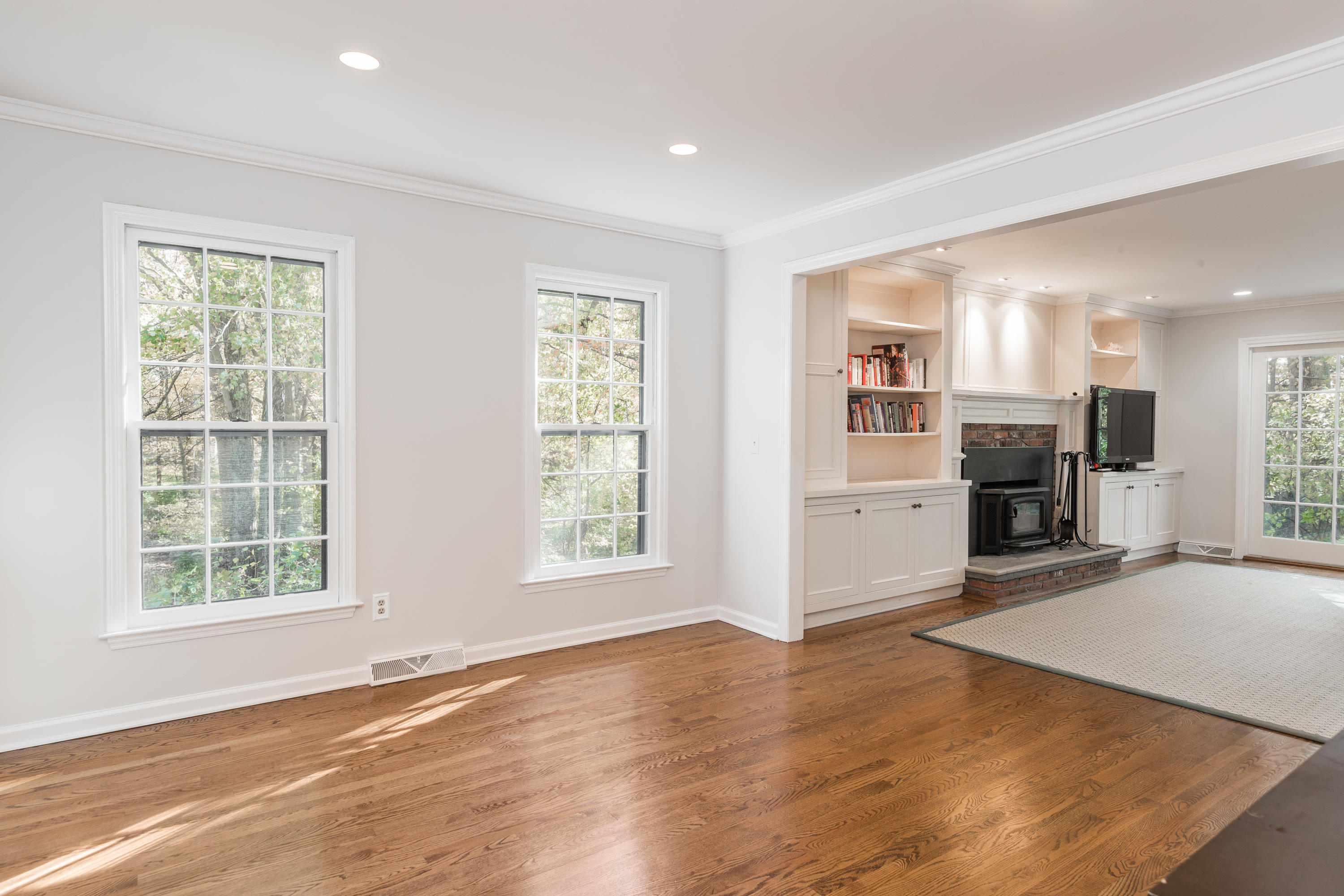 21 Barringer Road Darien, CT 06820 - Photo 9 of 34 an empty room with windows and a kitchen view