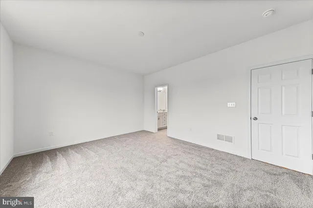 a view of an empty room and entryway