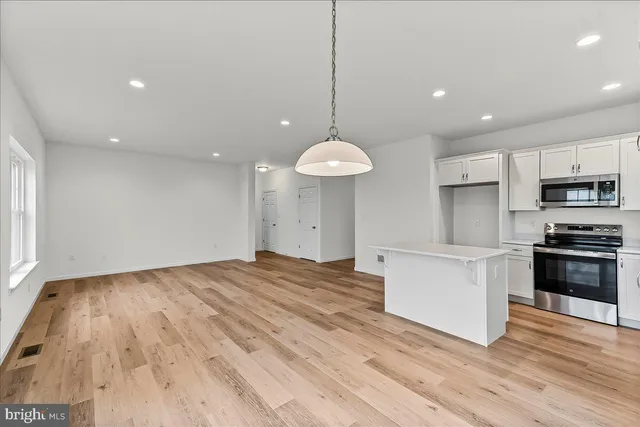 a view of a kitchen with stove and cabinets