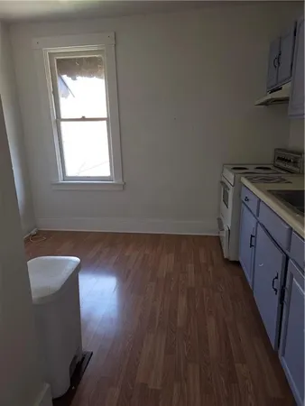 a kitchen with wooden floors and a sink