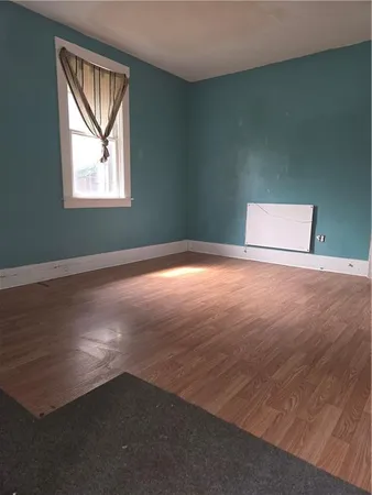 a view of a livingroom with an empty space and window