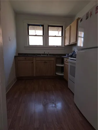 a kitchen with granite countertop a stove and a sink