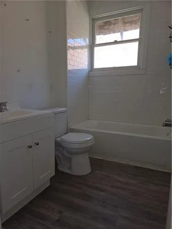 a bathroom with a toilet and a window