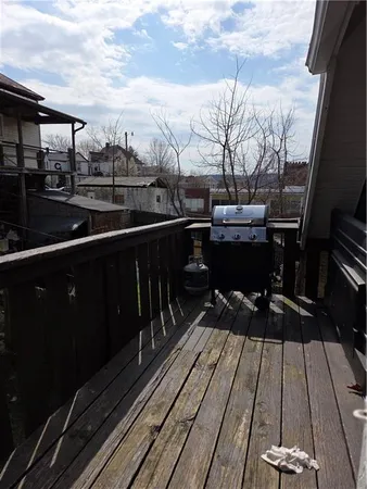 a view of a balcony with wooden floor