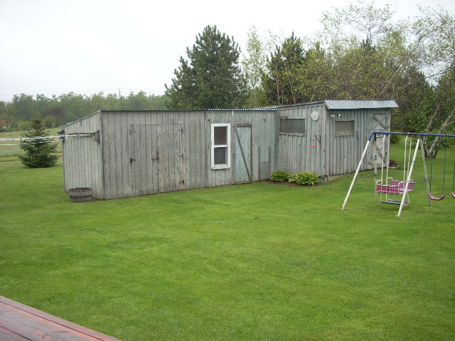 307 Loop Road Savoy, MA 01256 - Photo 14 of 20 a view of a backyard with a slide and a wooden fence