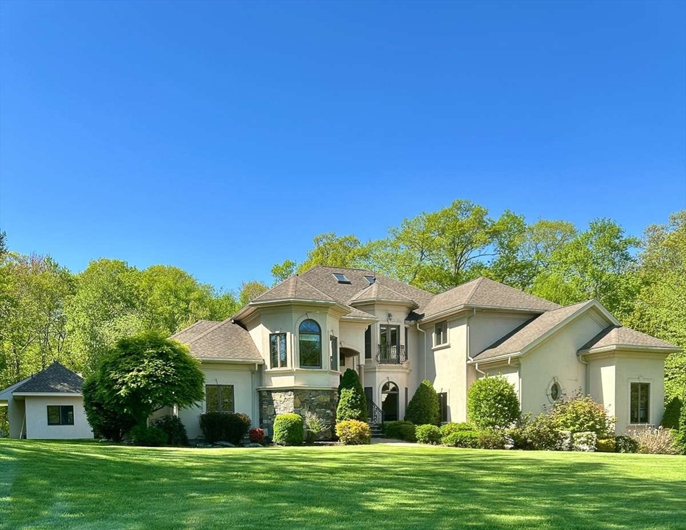 a front view of a house with a garden