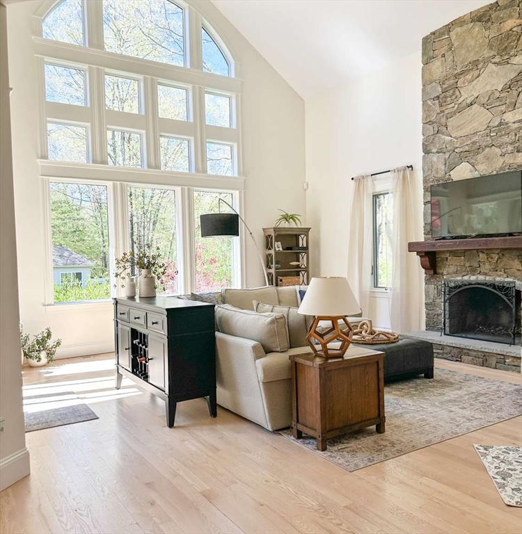 37 Putnam Hill Road Sutton, MA 01590 - Photo 11 of 42 a living room with furniture a large window and a fireplace