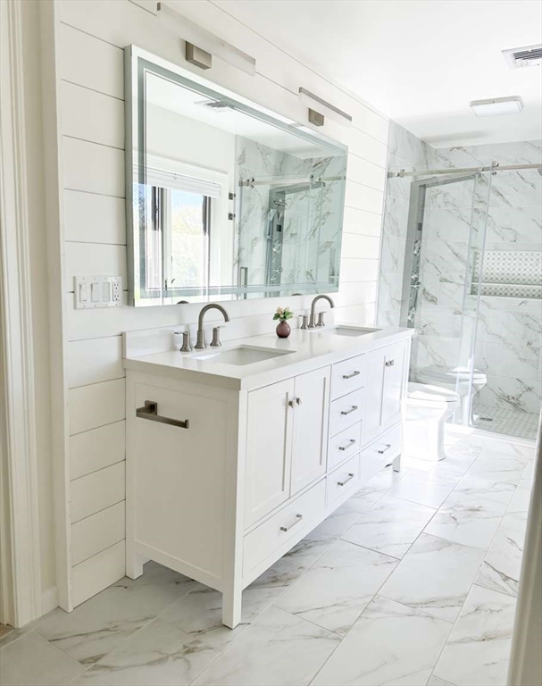 37 Putnam Hill Road Sutton, MA 01590 - Photo 26 of 42 a bathroom with a double vanity sink a mirror and a bathtub