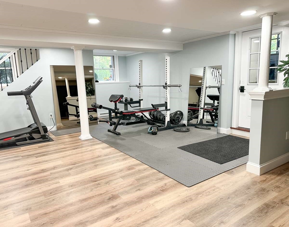 37 Putnam Hill Road Sutton, MA 01590 - Photo 35 of 42 a living room with furniture a large mirror and gym equipment