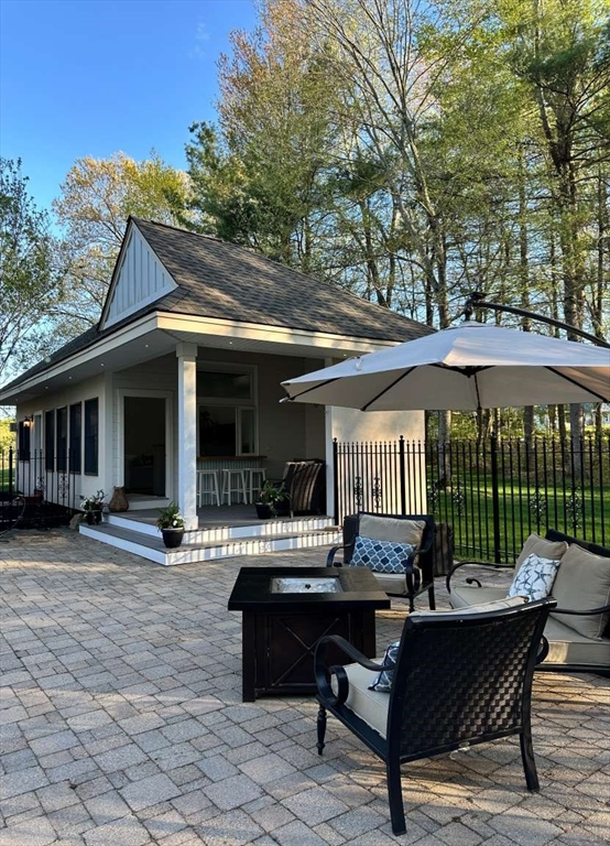 37 Putnam Hill Road Sutton, MA 01590 - Photo 37 of 42 a backyard of a house with barbeque oven table and chairs