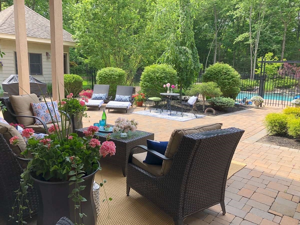 37 Putnam Hill Road Sutton, MA 01590 - Photo 5 of 42 a view of a patio with couches and table and chairs potted plants