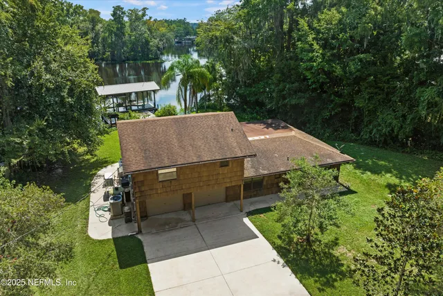 an aerial view of a house with swimming pool and garden