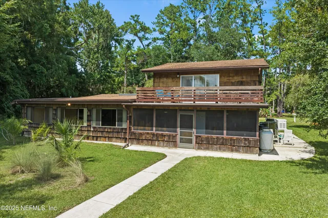 a front view of house with a garden