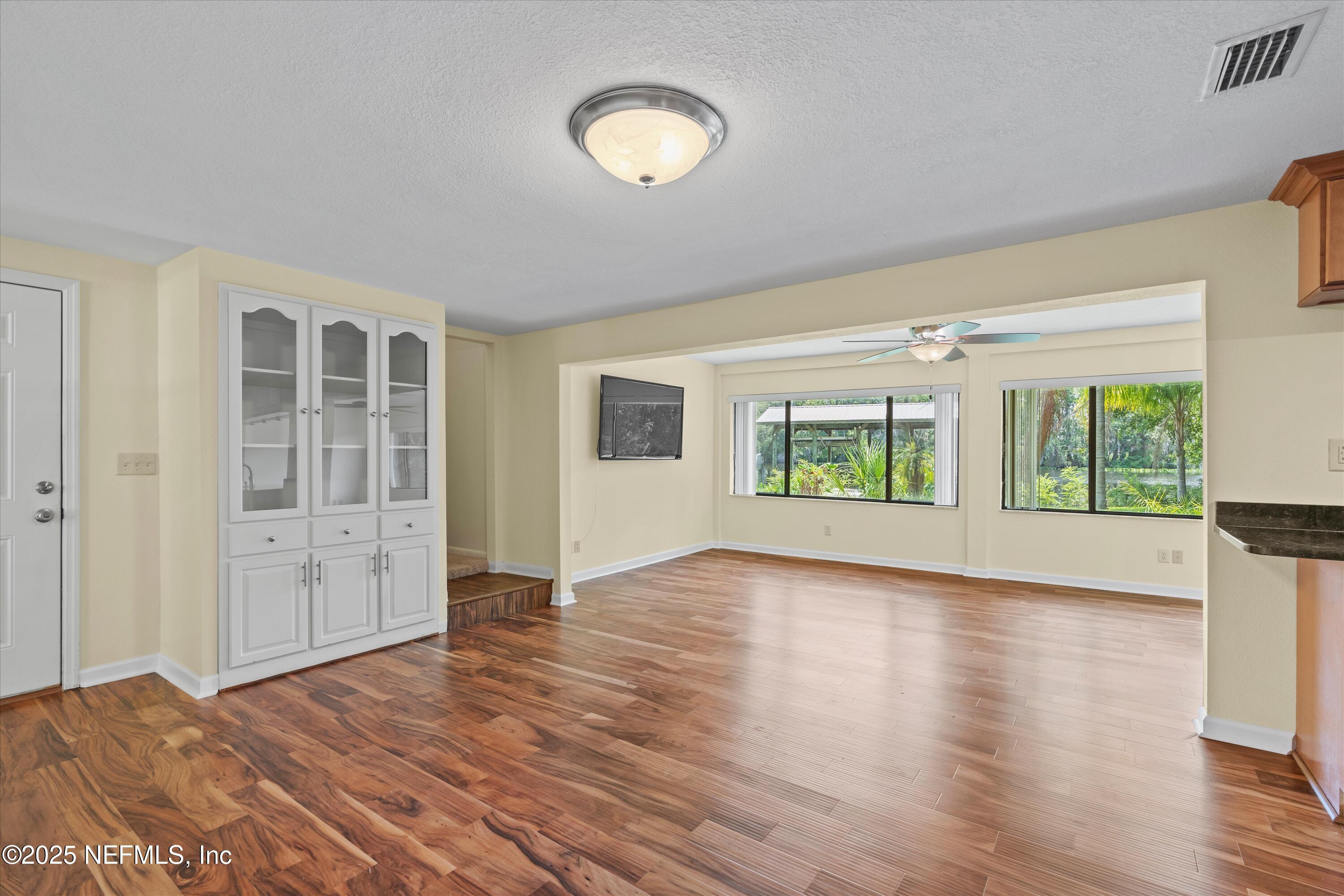 145 Finnigan Road Satsuma, FL 32189 - Photo 3 of 33 wooden floor in an empty room with a window