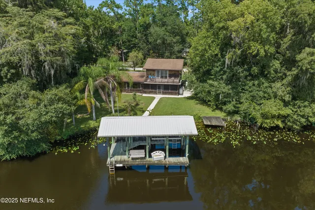 a aerial view of a house with a yard