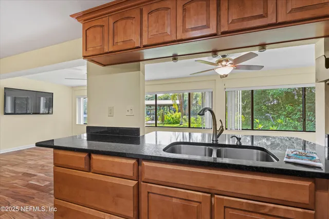 a kitchen with granite countertop a sink and a window