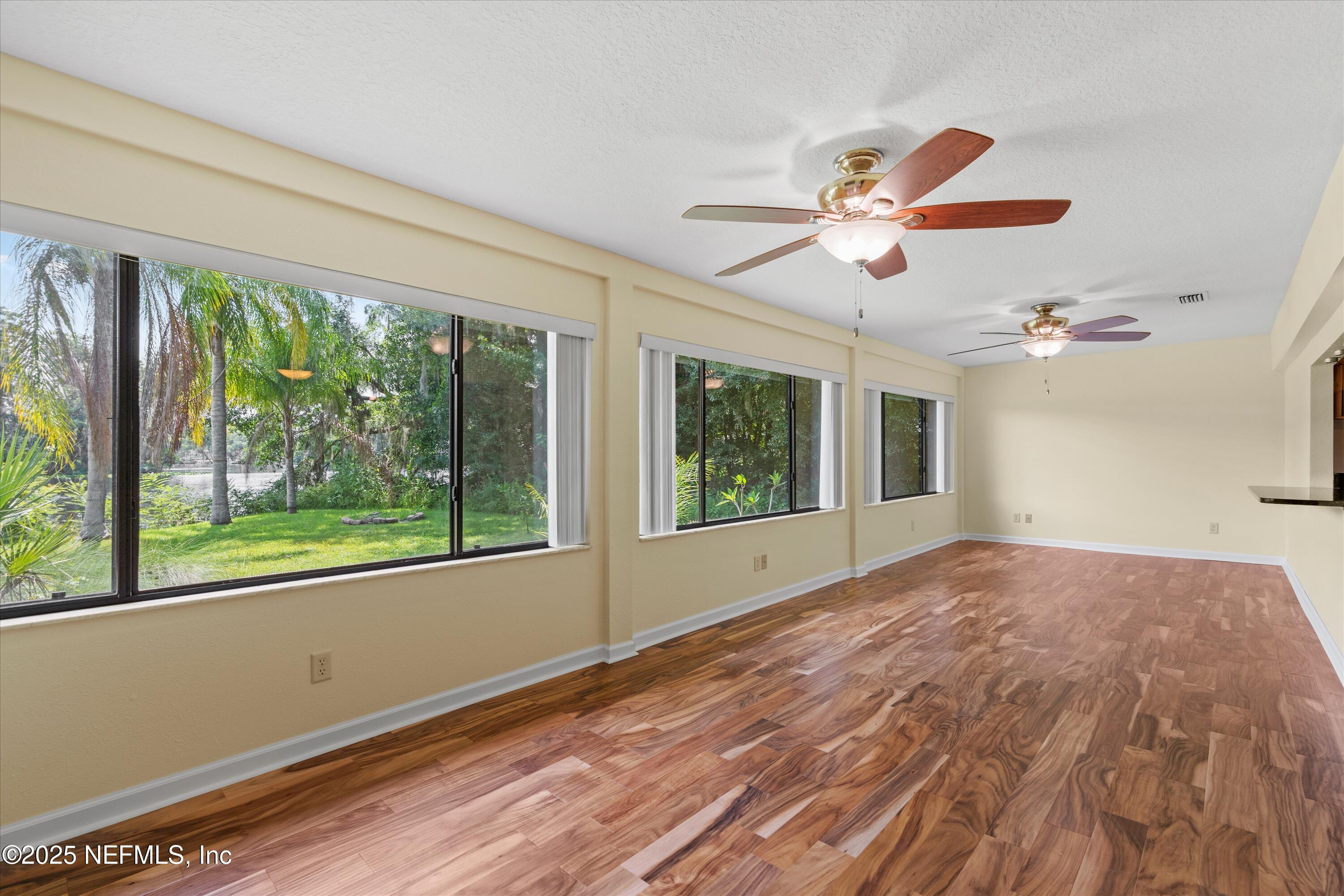 145 Finnigan Road Satsuma, FL 32189 - Photo 8 of 33 a view of empty room with wooden floor and fan