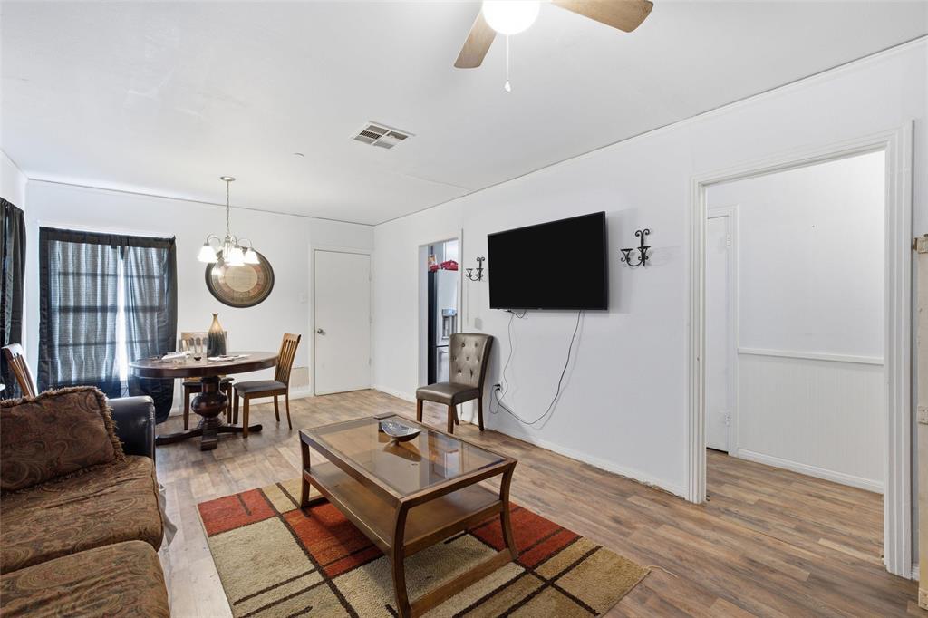 3329 Cumberland Avenue Waco, TX 76708 - Photo 3 of 8 a living room with furniture a flat screen tv and kitchen view