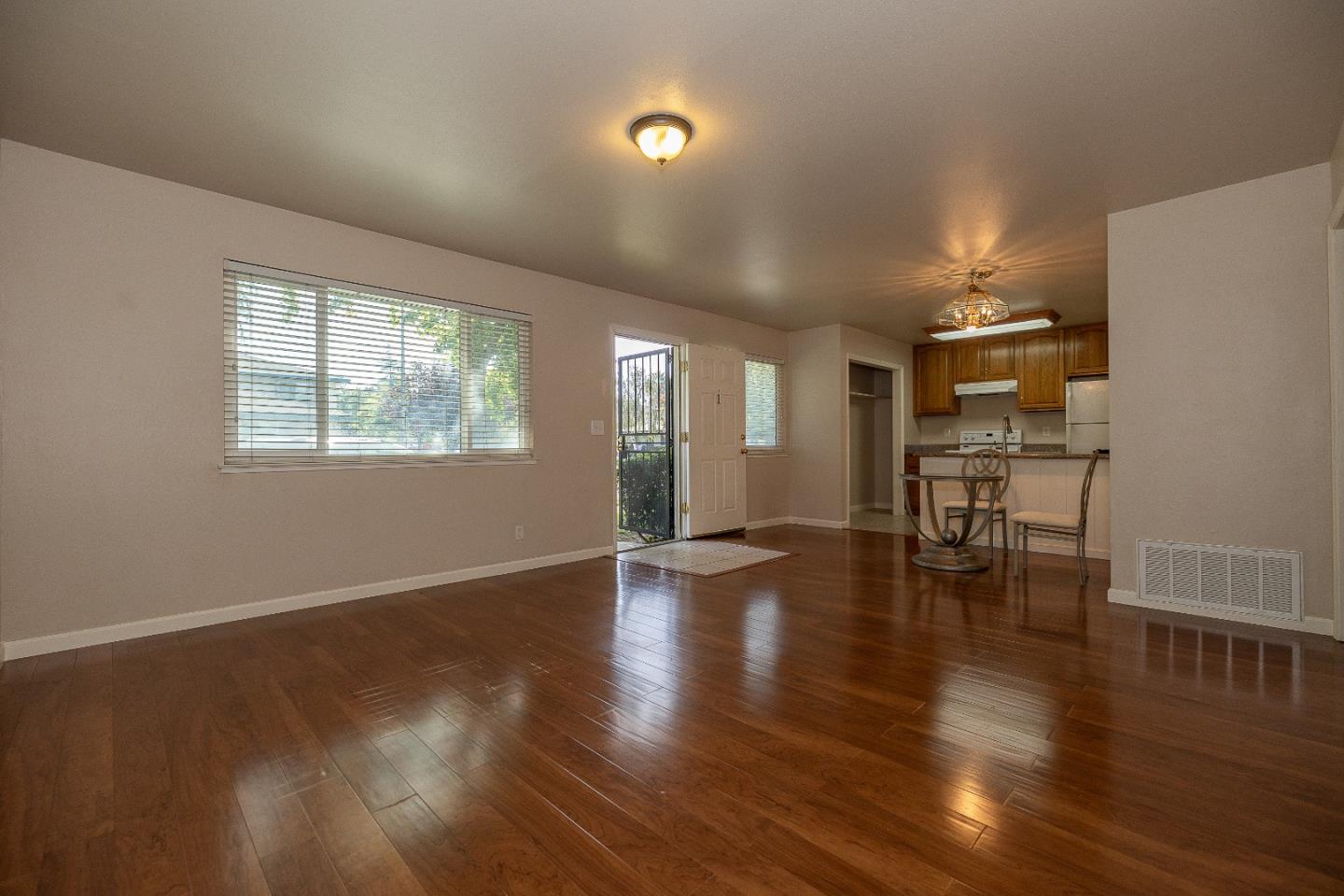 207 Watson Drive, Unit 1 Campbell, CA 95008 - Photo 4 of 17 a view of a room with wooden floor fire place and windows